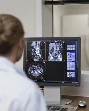Doctor Operating CT Scanner